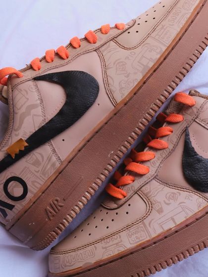 Another angle of the custom Arweave x ETH Mumbai sneakers. This shot highlights the hand-painted black swoosh and the subtle texture of the coffee-dyed leather, a process that makes each pair unique.