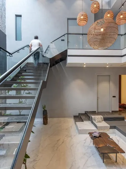 A view up the staircase at Casa Acentuada, demonstrating how we design for movement and experience. The glass railing ensures unobstructed views across the open-plan space.