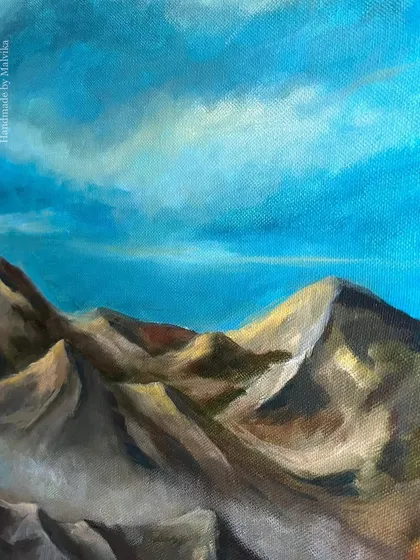 A work-in-progress shot of a large acrylic mountainscape on canvas. This piece is all about capturing the grandeur of the Himalayas under a dramatic blue sky, using bold brushstrokes and a rich color palette.