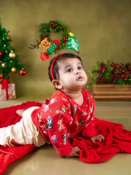 Tummy time by the tree. This is a great pose for younger babies during a festive session.