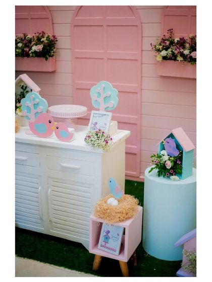 Another view of the birdhouse-themed dessert table, showcasing the sweet and charming details.