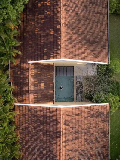 An aerial drone shot of a villa at Dvara Resorts, showing the private plunge pool nestled between two sections of the building. This unique perspective highlights the resort's thoughtful and luxurious layout.