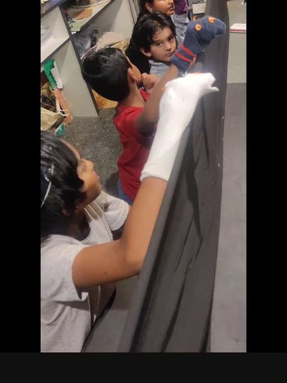 Students work with sock puppets, another fun way we introduce the principles of puppetry and character creation in our workshops.