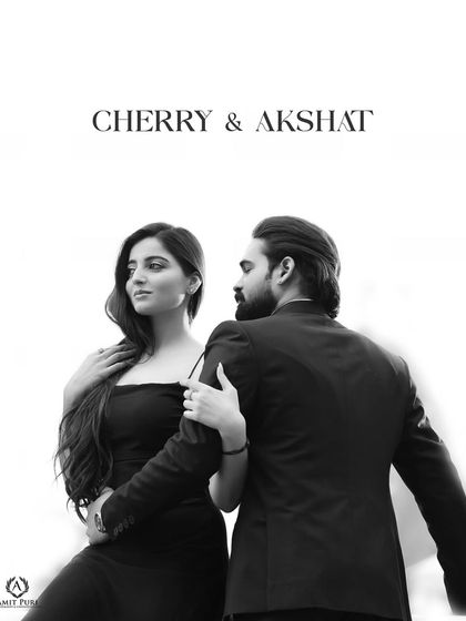 A stylish black and white shot with a magazine-cover feel. The clean white background and the couple's pose create a modern, high-fashion portrait that is both bold and elegant.