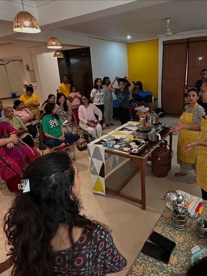 Students gather enthusiastically for a cooking demonstration, eager to learn the secrets of our light and nourishing ashram cuisine.
