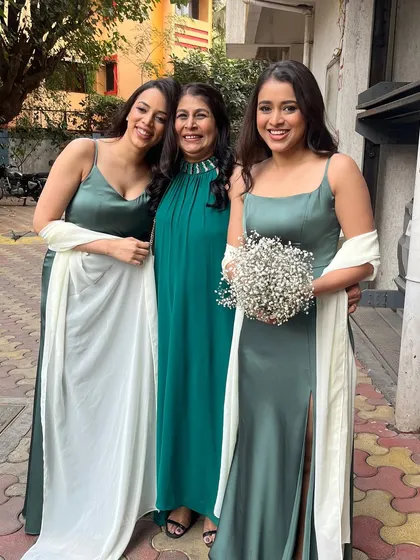 A beautiful photo of two bridesmaids with a family member. It's always a joy to get the whole family glammed up.