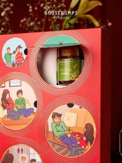 Revealing a jar of Pani Puri Cashews from my "Nok Jhok" Raksha Bandhan box. The unique packaging with tear-open windows is designed to make the gift-giving moment playful and memorable.