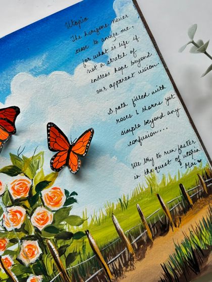 A detail shot of the handwritten poem next to the painted butterflies and roses.