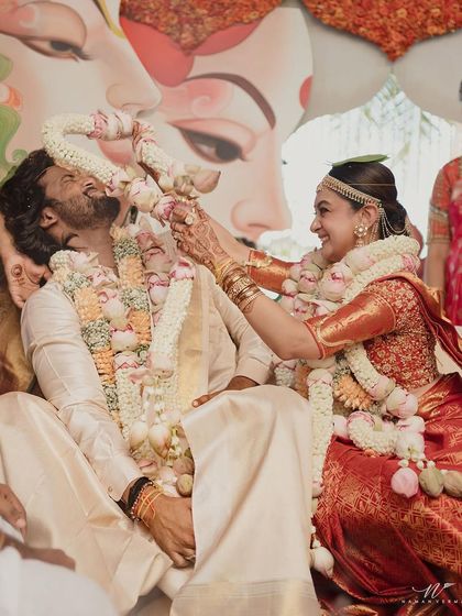 A playful moment during the wedding rituals. Our goal is always to create a look that allows the bride to feel like herself and enjoy every second of her wedding day without worrying about her makeup.