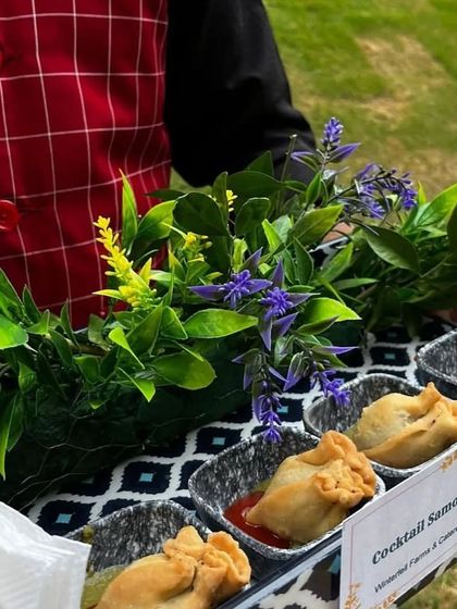 Cocktail Samosas served in individual portions on a decorated tray. This is a classic Indian snack that we present elegantly for easy serving at events.