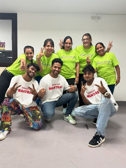 The "Sassy Shufflers" crew and their instructors, all smiles and peace signs. This is what our happy dance family looks like.