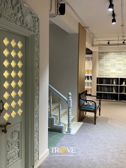 The entrance to our Whitefield showroom sets a tone of traditional elegance. The intricately carved door and classic tile patterns in the background hint at the blend of heritage and luxury you'll find inside.