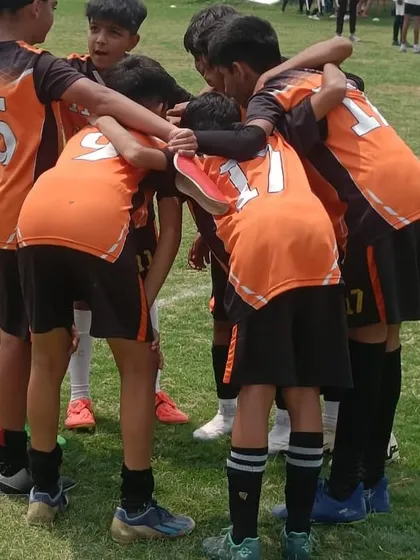 A team huddle showing the unity and spirit of our young players.