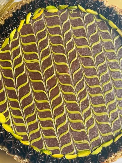 My take on the viral trend: the Dubai Chocolate Cheesecake Tart. It features a crunchy pistachio cream Kunafa base, a rich cheesecake layer, and an indulgent chocolate ganache topping.