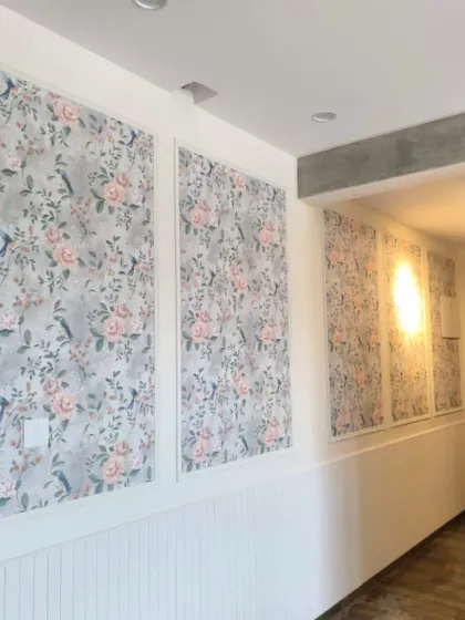 A classic and elegant look achieved by installing floral wallpaper within wall panels. This technique adds texture and definition, turning a simple hallway into a sophisticated space.