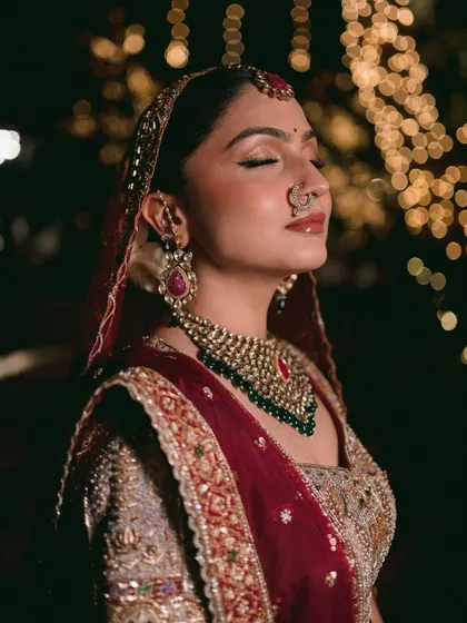 A bridal portrait is more than just a photo of the bride; it's about capturing her essence right before she begins her new chapter. This close-up, with the soft focus and bokeh lights, highlights the serene, dreamlike quality of the moment. It’s an artistic shot that focuses on emotion and beauty.