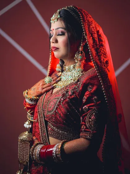 A soft and elegant pose contrasted with dramatic red lighting, showing the versatility of this creative style.