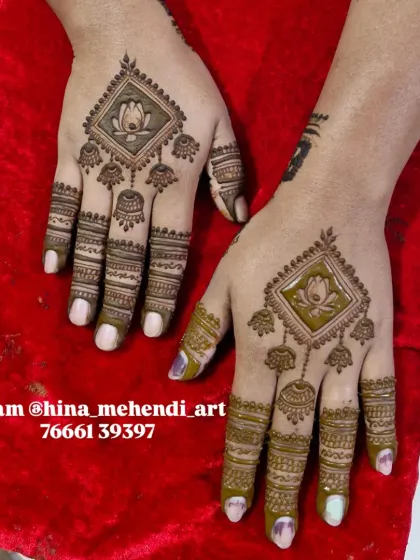 A simple yet beautiful design for a guest, featuring a lotus inside a diamond frame with hanging jhumka (earring) motifs.