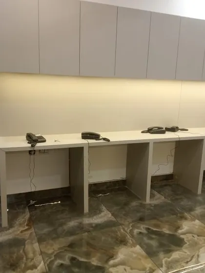 A long office desk with multiple telephone handsets installed, ensuring seamless communication across the team.