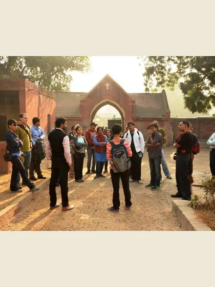 A group stands at the entrance of Nicholson Cemetery at sunset. Here, I introduce the complex character of John Nicholson and the role he played in the siege of Delhi.