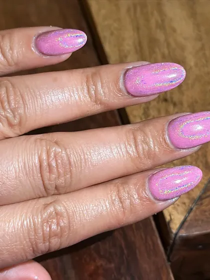 A detailed view of the aurora shimmer effect on these pink nails. The subtle swirls of glitter are just gorgeous.
