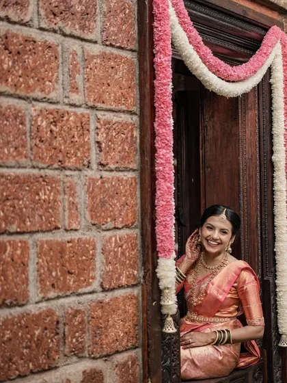 This shot captures the beautiful architecture and decor of the wedding venue. The bride's look is designed to be in harmony with her surroundings.
