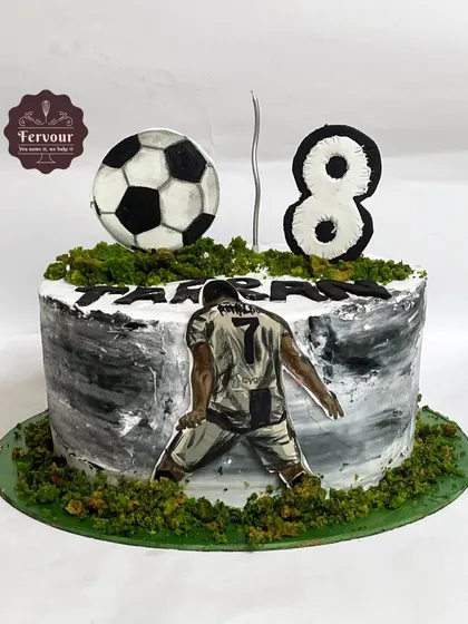 A football and Ronaldo theme cake for an 8th birthday. This cake has a painted texture and is decorated with a fondant football and a picture of the famous player.