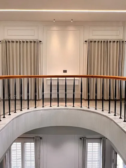 A view from the mezzanine in a grand residence by Aura Designgram. Our bespoke console table can be seen below, perfectly proportioned for the space under the elegant wall paneling.