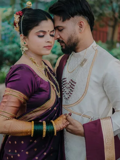 A quiet, intimate moment between the couple, their foreheads touching. This pose emphasizes their emotional bond, with the soft focus on their faces making it a very personal and romantic portrait.