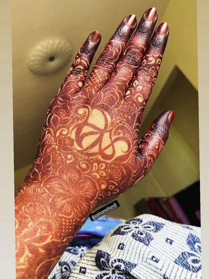 A unique design featuring a custom symbol in the negative space on the palm, surrounded by a delicate floral pattern.