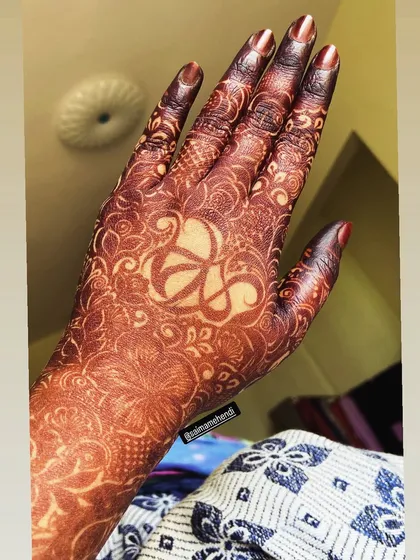 A unique design featuring a custom symbol in the negative space on the palm, surrounded by a delicate floral pattern.
