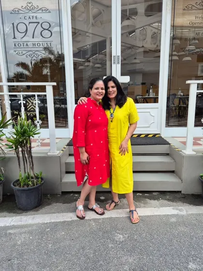 Another full-length shot with my friend, capturing our fun and colourful brunch outfits.