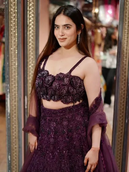 A closer look at the 3D floral details on this glamorous purple lehenga blouse.