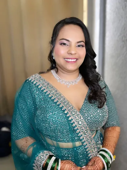 My beautiful bride Priya, ready for her reception. She wore a stunning teal lehenga, and I created a soft glam makeup look with a focus on radiant skin to complement it.
