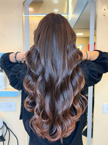 A rich brown for a sophisticated look. We gave our client this elegant chocolate hue with a subtle ombre effect, creating a timeless and classy transformation.