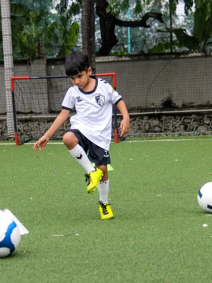 A young player practices ball taps, a simple but effective exercise for developing a feel for the ball and improving coordination.