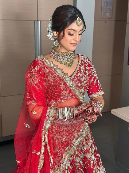 Adjusting her jewelry, the bride looks serene and beautiful. The beauty of this look is in the subtle details, creating a soft and zen-like bridal aura.