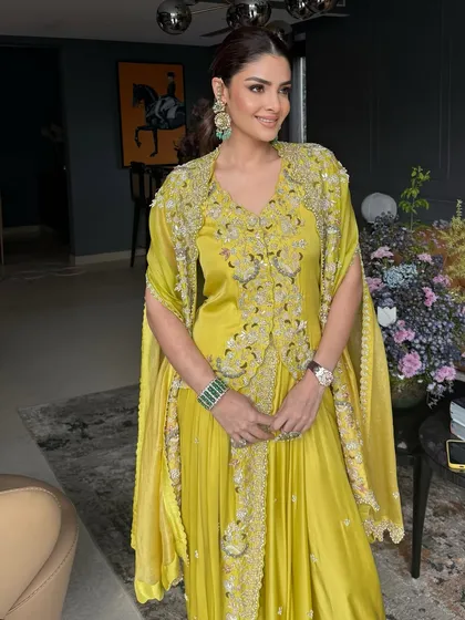 The full daytime look for Priyanka. Her makeup is perfectly balanced with her vibrant outfit and elegant jewelry.