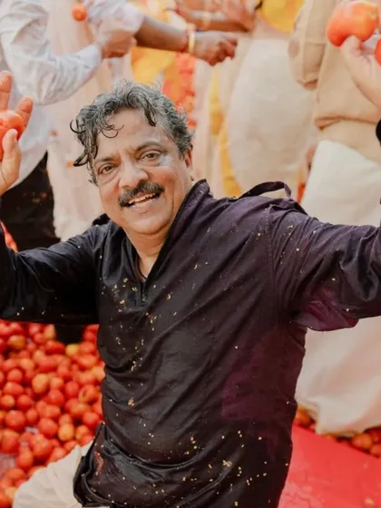 Pure joy amidst the tomatoes. This guest's expression captures the fun and carefree spirit of the unique La Tomatina Haldi celebration we planned and executed.