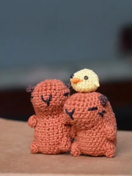 Two little capybaras with a tiny chick on top. This is one of my favorite scenes to set up, showing a moment of calm and friendship between different animals.