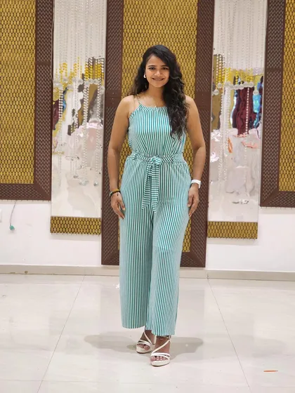 A simple, full-length shot of a chic striped jumpsuit. This is a great example of a smart-casual look for everyday fashion brands.