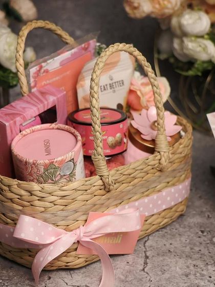 A lovely pink basket hamper for Diwali. The polka-dotted ribbon and curated pink-themed items make it a cheerful and charming gift.