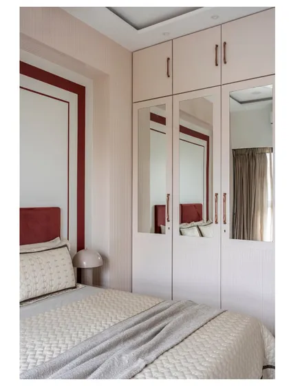 The other side of the guest bedroom, showing the blush-toned wardrobes with integrated mirrors, which help make the space feel larger and brighter.