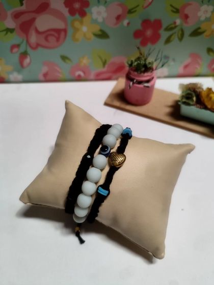 My collection of handmade bracelets, available in many colors and styles. I use beads, evil eye charms, and macrame techniques to create these stackable pieces.