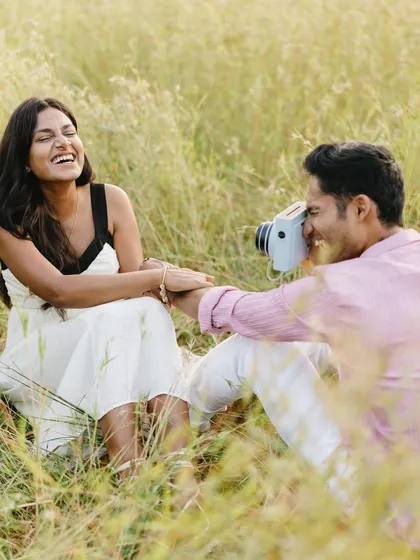 The best moments are often the ones filled with genuine laughter. Here, he captures her with a polaroid camera, and her uninhibited joy makes the photo truly special.