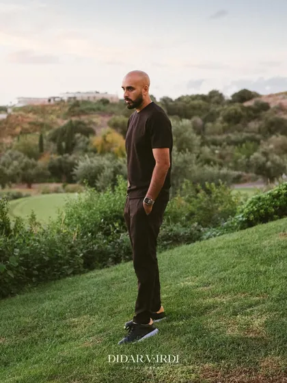 A solo shot against the green hills of the Greek countryside. The contrast between the vibrant party and the serene landscape is amazing.