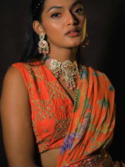 A model showcasing a unique, artistic choker with pastel pink and green stones. This is perfect for an indo-western look for a mehendi or sangeet.