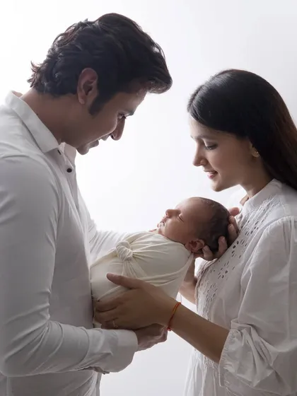 A classic portrait that every new parent treasures. We used simple, clean lighting in our studio setup to focus entirely on the quiet, powerful bond between mom, dad, and their newborn. It’s a timeless image of a family's beginning.