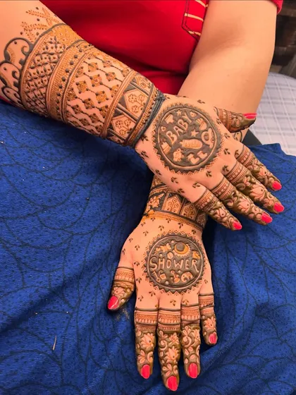This custom baby shower mehndi is one of my favorites. I incorporated circular panels with "Baby" and "Shower" text, surrounded by tiny, cute motifs like rattles, feeding bottles, and little animals to celebrate the mom to be.