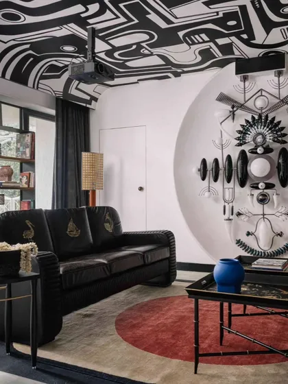 Another view of the labyrinth ceiling, showing its relationship with the custom totem light fixture and the room's bold, monochrome design.